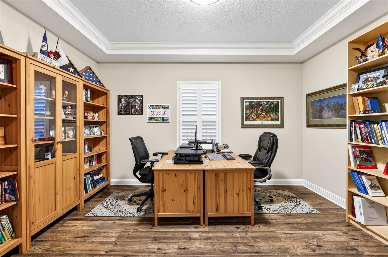 Office space with plantation shutters and french doors.