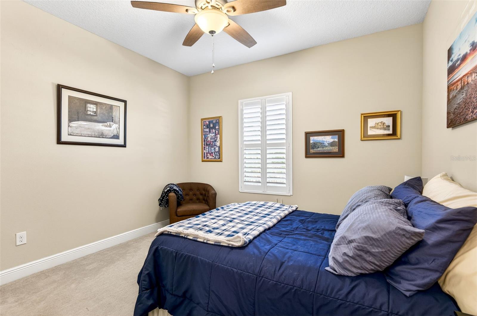 Bedroom #2 with plantation shutters and ceiling fan