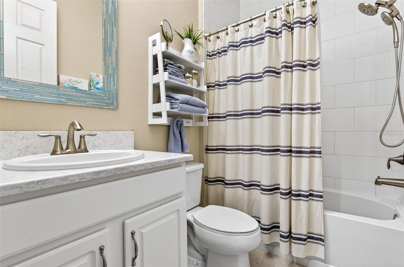 Bathroom #2 with comfort height vanity and upgraded shower heads. Shower/tub combination and linen closet