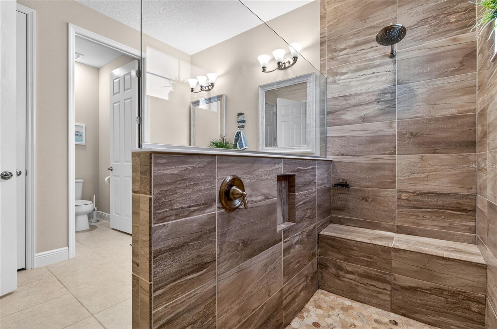 Walk in shower with built in bench and niche for shower products