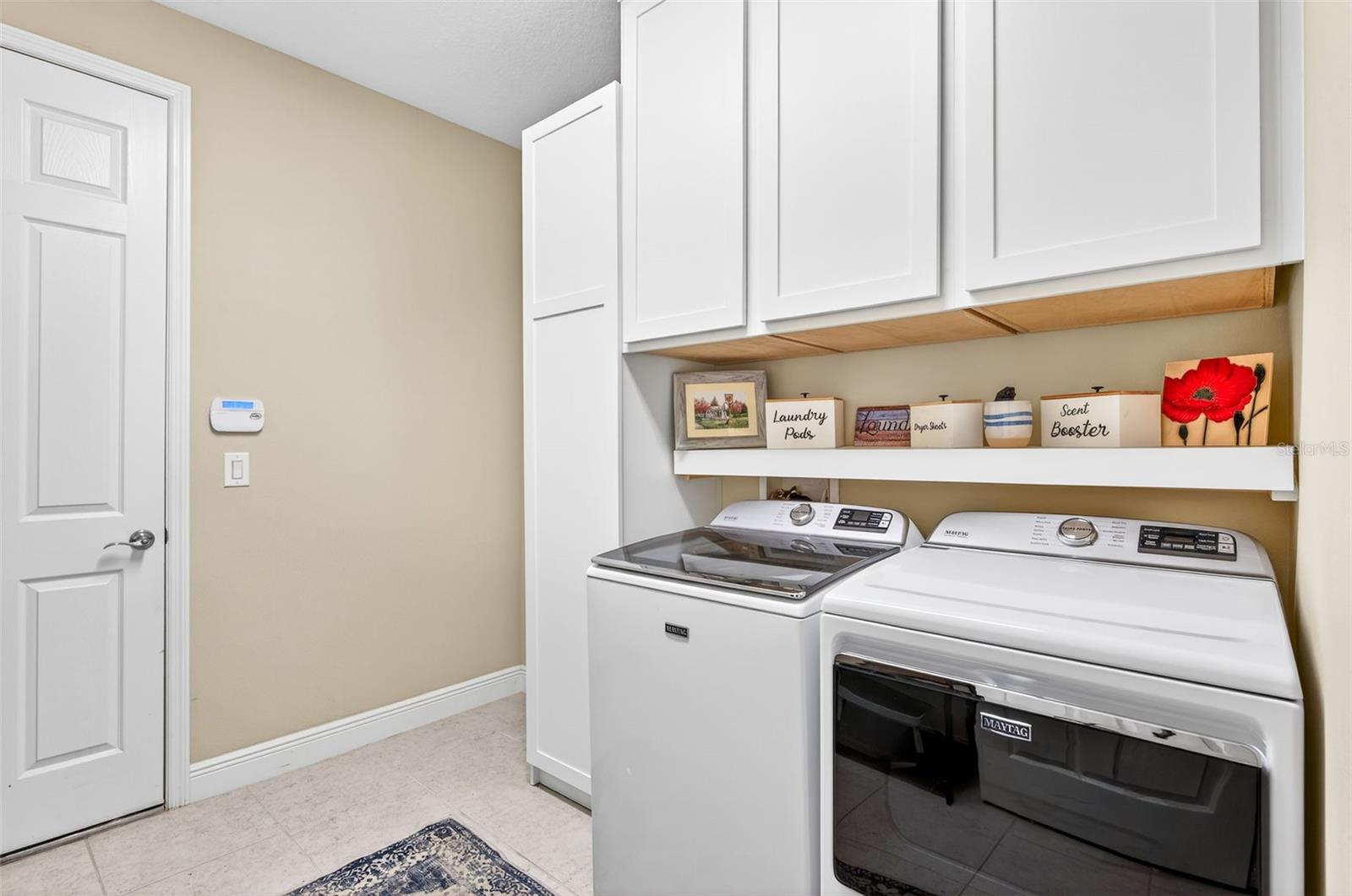 Laundry room with built in cabinets/shelves