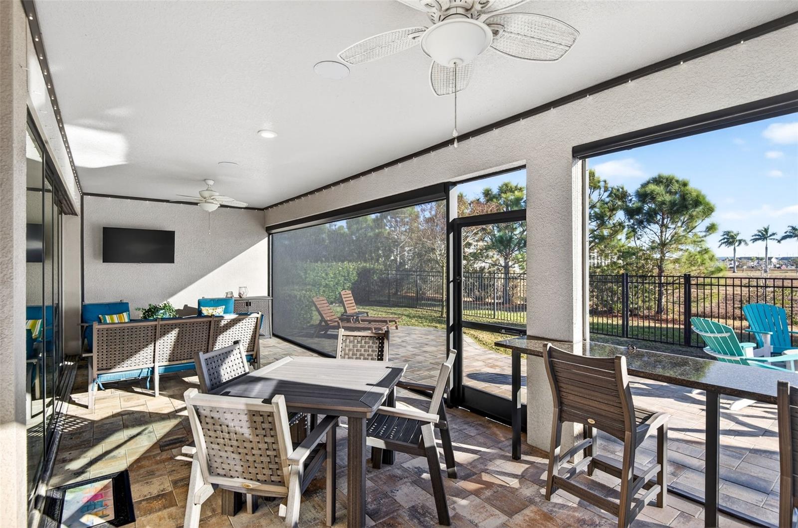 Screened, covered lanai with built in bar. Remote control will raise the screen to desired height. Trim lights perfect for setting the mood on the lanai