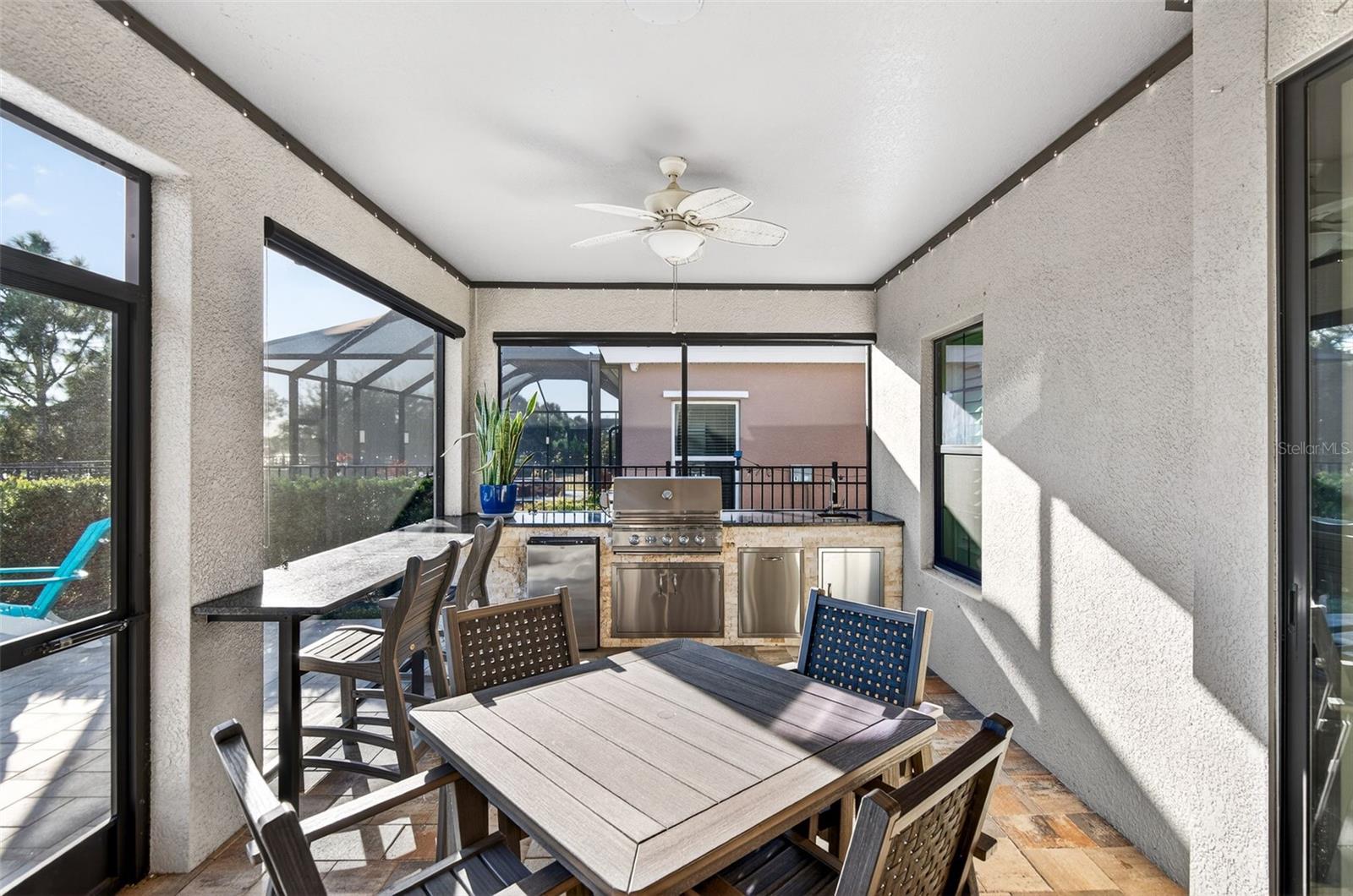 Built in bar and outdoor kitchen complete with grill, sink and refrigerator.
