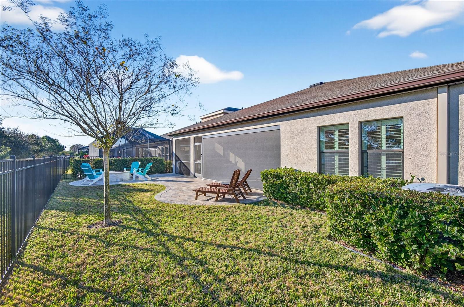 Fully fenced backyard and extended, architecturally pleasing, pavered fire pit and lounging area