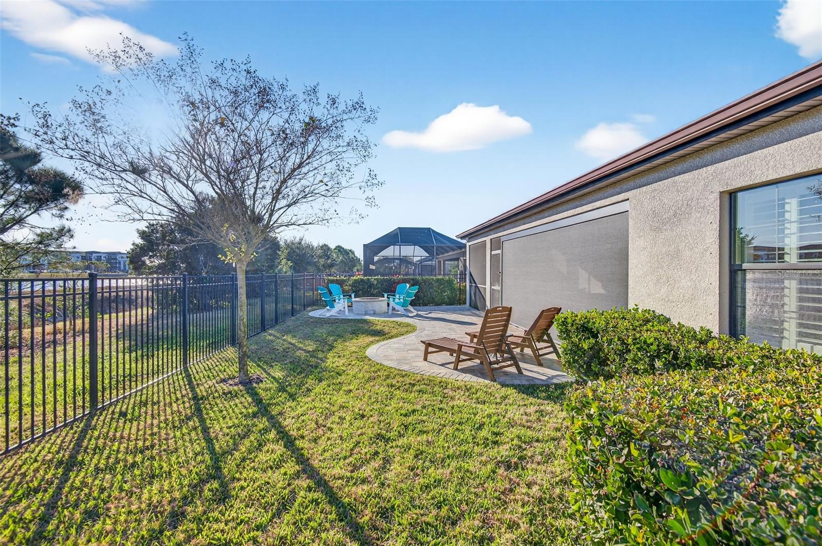 Fully fenced backyard with view of pond.