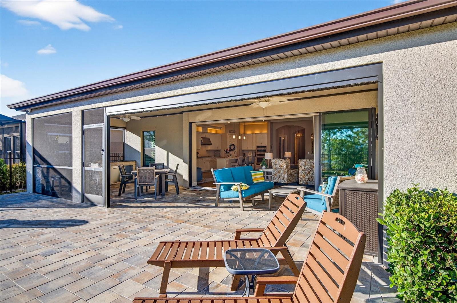 View from back of lanai with screen raised and sliding glass doors completely open.