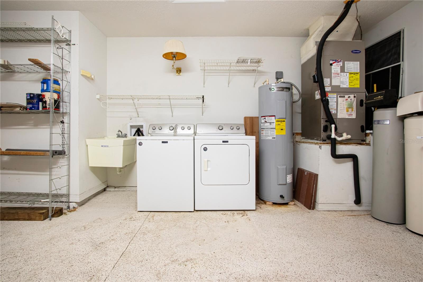 Washer/dryer  and sink in garage area