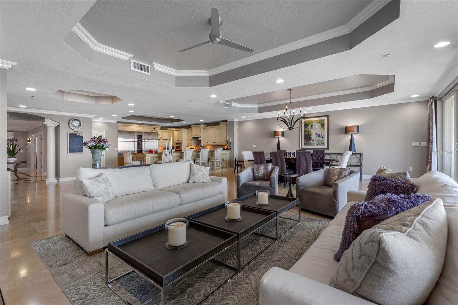 .. 1250 Sq Ft Great Room View from the Living Room Area Looking Towards Kitchen. High End Construction. 10 Foot Tray Ceilings - Custom Crown Molding & Base Boards - Travertine Marble Flooring Plus Ample Lighting.