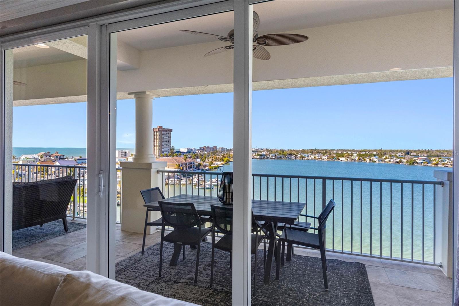 ..  60' Terrace Photo From Great Room Living Area.. Great Room Area Enjoys a 30' Wall of Floor To Ceiling High Impact Sliders. The Master Suite & Art Studio have another 30' Run of Sliders. This PH Home Would Run About $3.5 To $4.5 across the Street. That is Without the 24/7 Secured Access - Clubhouse - Gym- Tennis & Pickle Ball Courts & Dog Walk All Located on a 24 Acre Private Development Site With On-Site Manger.  Enjoy The 2 Tours.