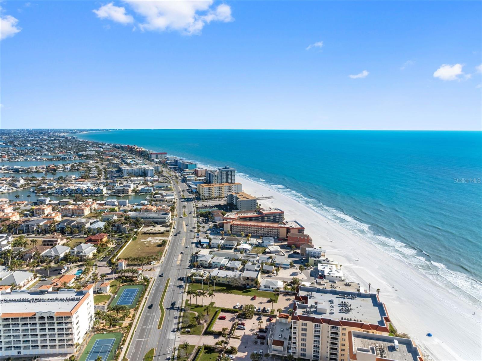.. Redington Shores Looking South. Small Beach Community - Family Oriented. 22 Miles due West of Tampa Airport. RSY&Tennis Club is on Left in Photo. NOTE : Tennis & Pickleball Courts Behind Security Gate. Please Watch Vimeo Aerial Tour.
