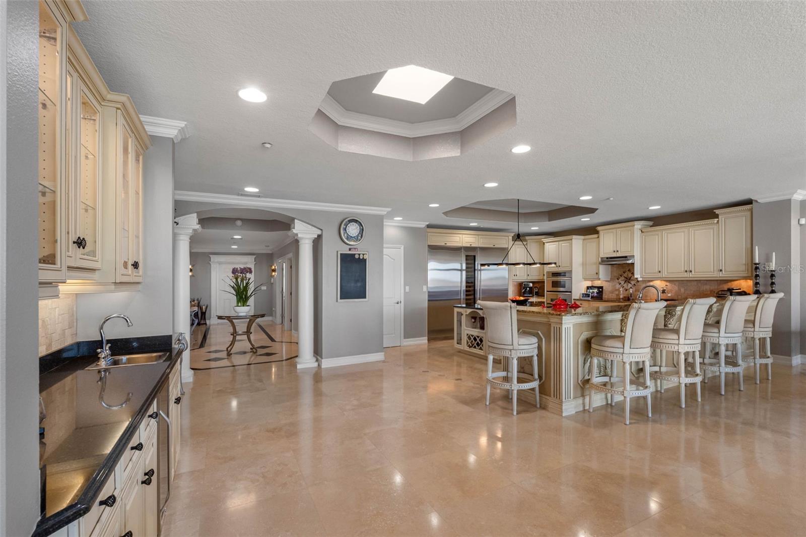 .. Photo  From The Redesigned Wet Bar Towards Kitchen Area. Very Functional Layout. NOTE: Hexagon Skylight Affording Natural Light Over Kitchen & Foyer Area. Main Guest Bedroom tHru Hallway On Left.