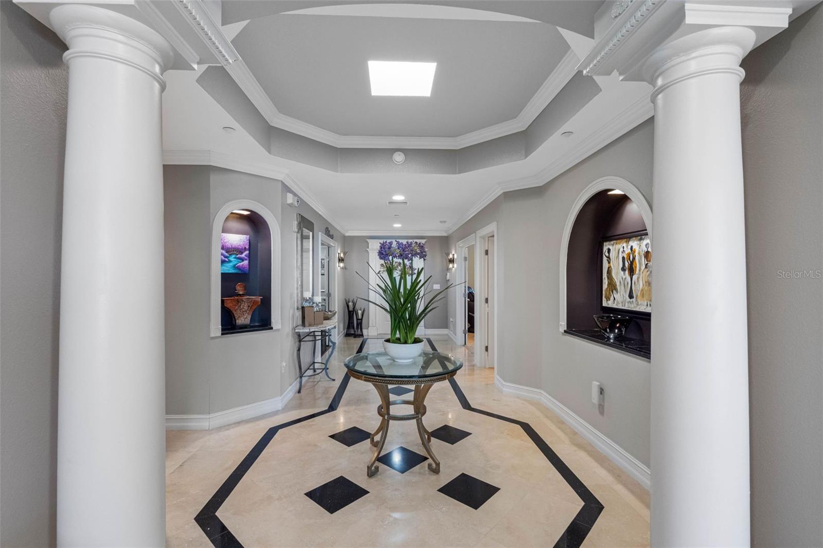 .. A 28' Grand foyer with 10' tray ceilings, skylight, art alcoves and 24” travertine marble flooring with Black Galaxy granite inlays. The attention To Detail Shows Thru- Out PH Residence 702. Private Tours are Welcome, Just Call.