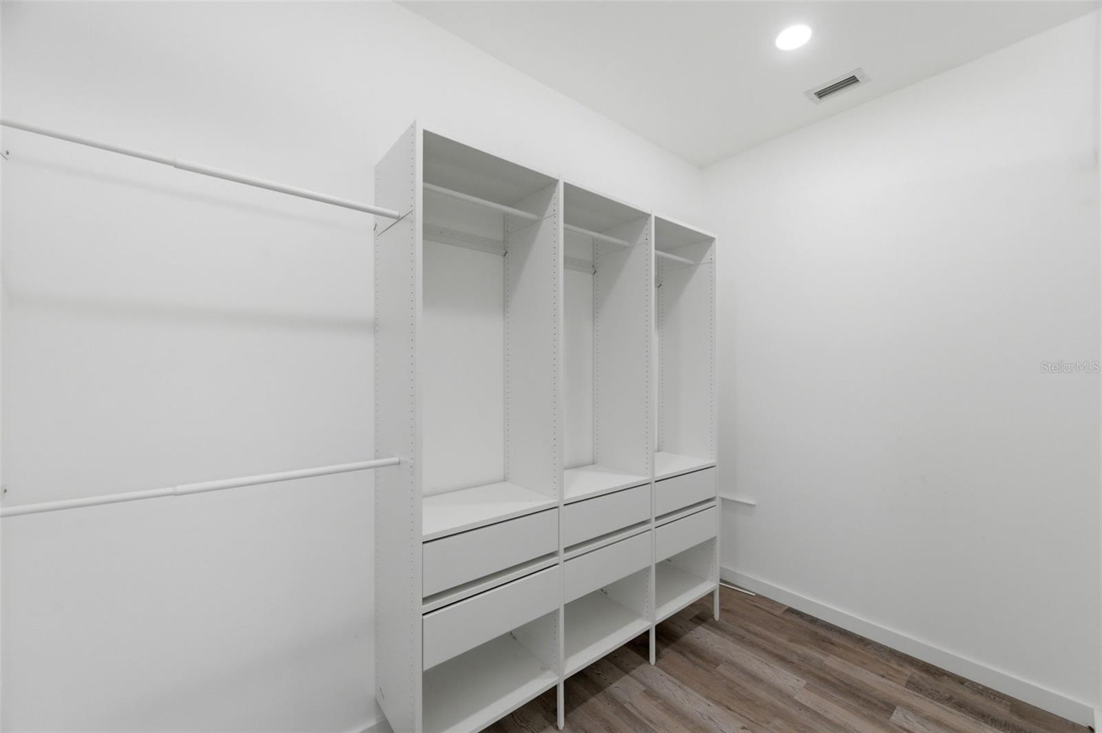 Walk in closet with custom build ins.