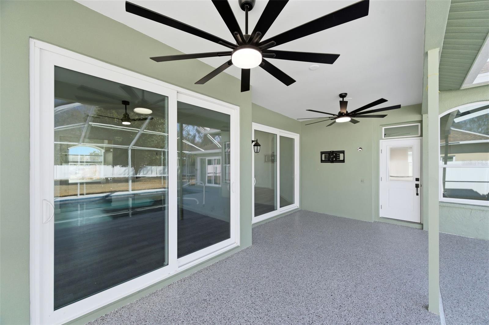 Entertaining is a delight inside or out with this open floor plan and multiple sets of sliding doors.