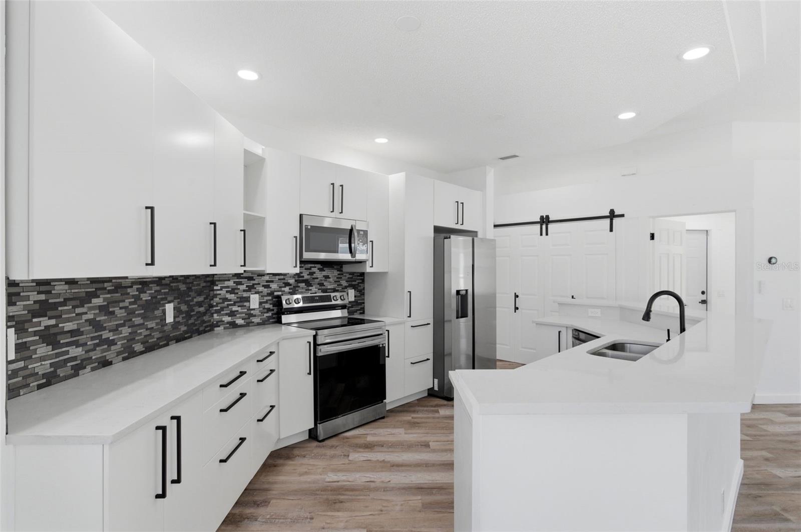 High end cabinetry and designed backsplash make for easy cleaning.