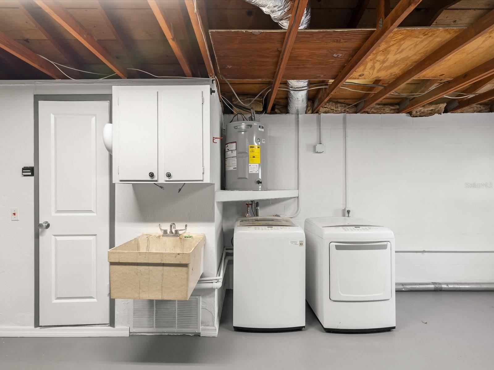 Garage sink and laundry area, bathroom to the right of this photo with toilet and shower