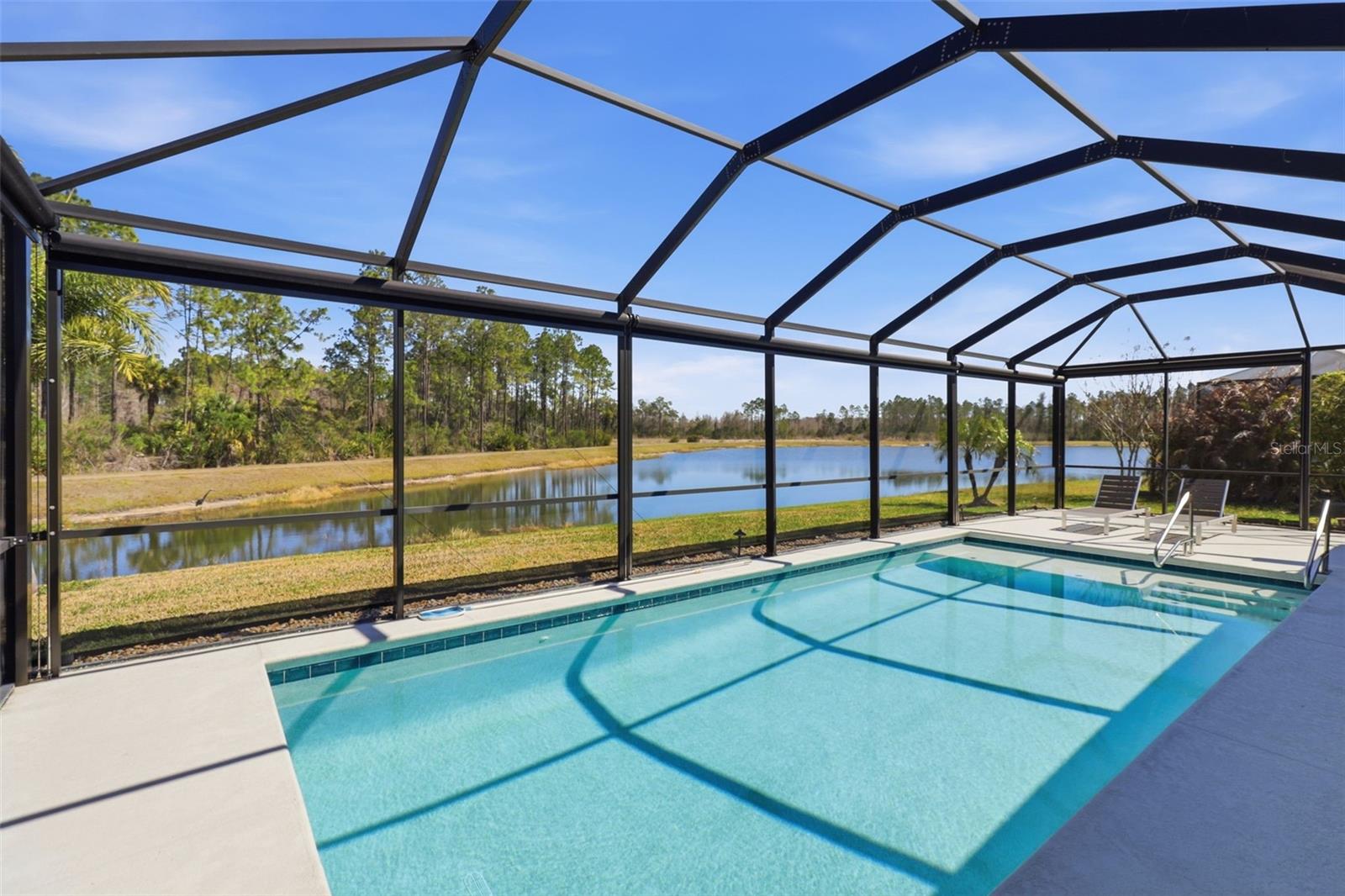 Relax by the pool with views of the pond