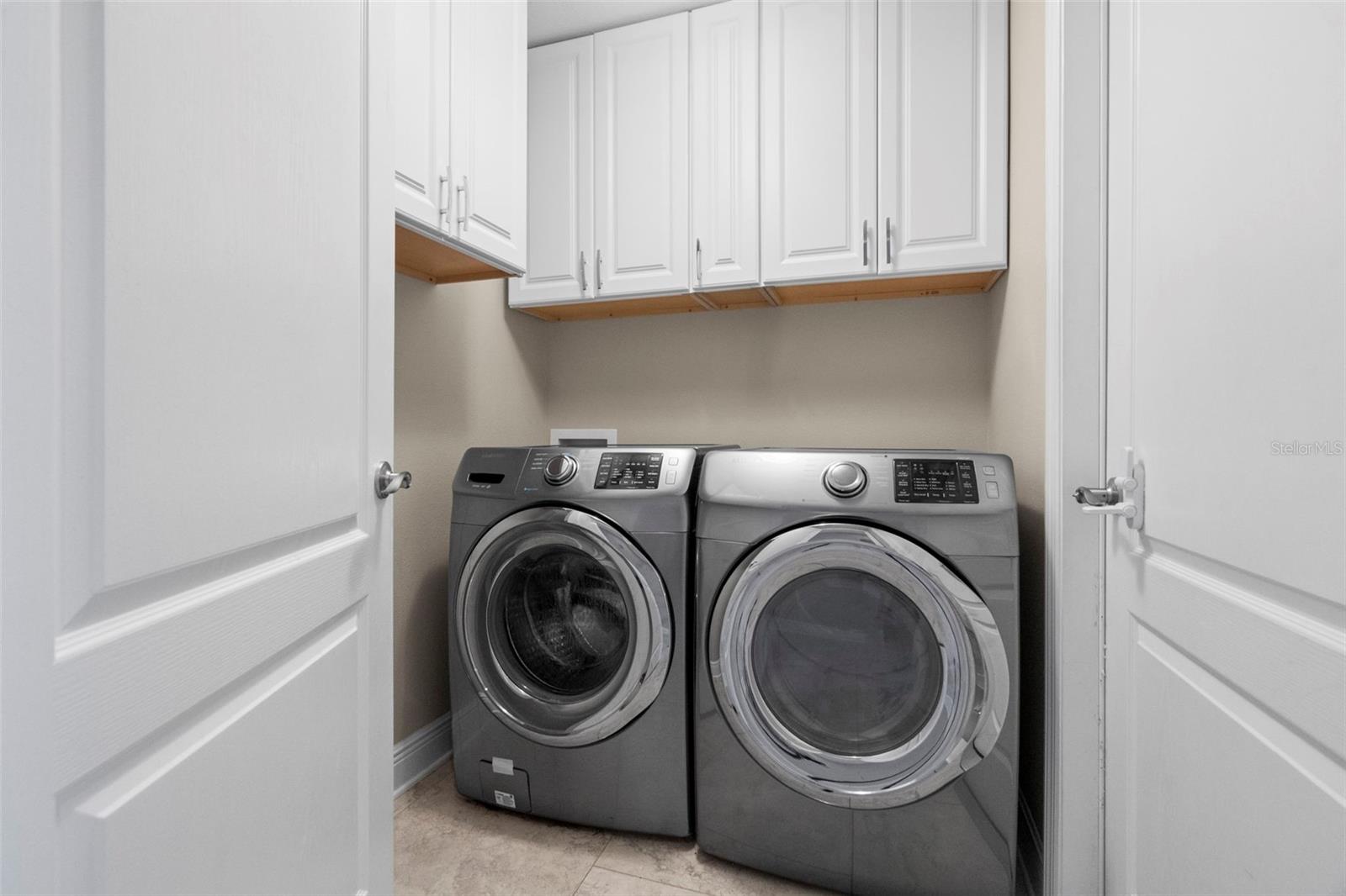 Indoor laundry with beautiful front load washer & dryer