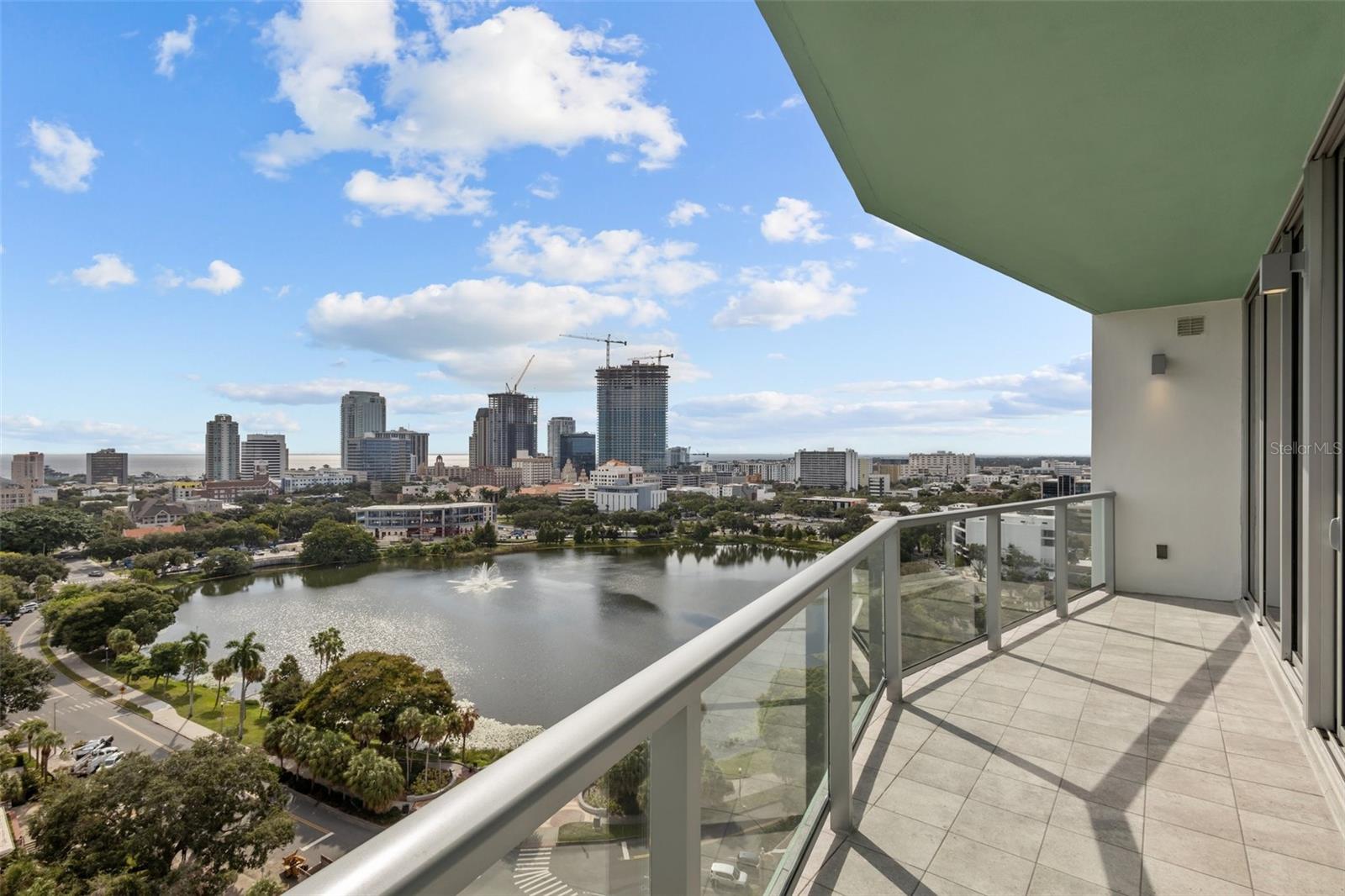 Expansive 30-foot-wide private balcony showcasing breathtaking views of Tampa Bay, the St. Pete skyline, and the Sunshine Skyway Bridge.