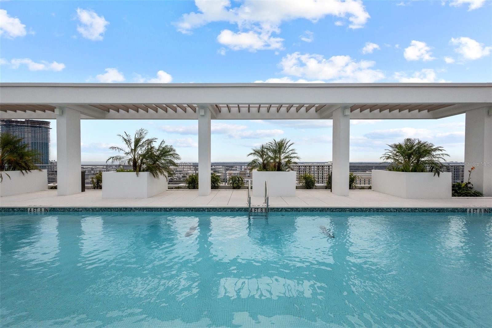 Resort-style rooftop pool and hot tub designed for relaxation with unmatched skyline and water views.