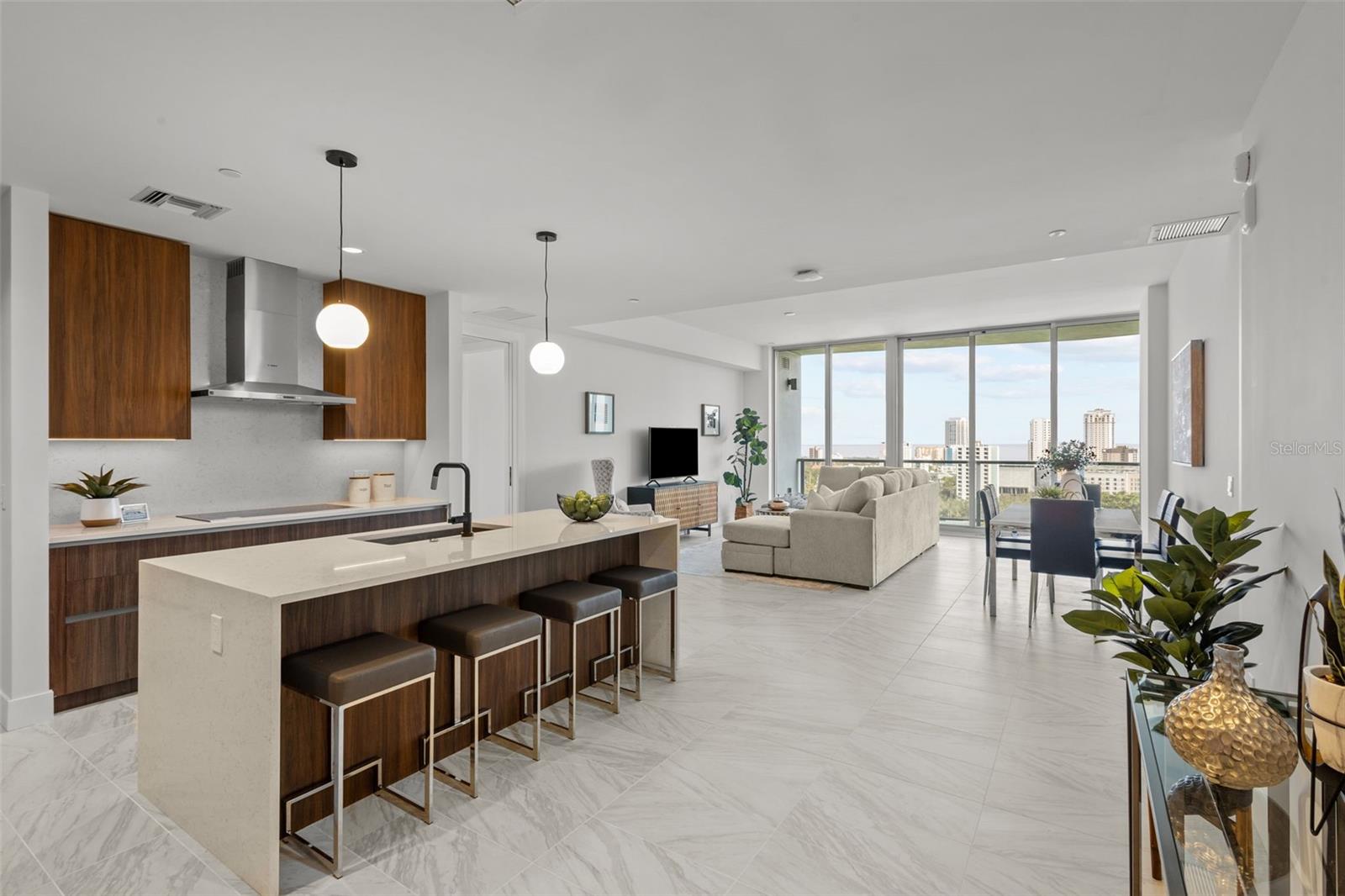 Chef-inspired kitchen featuring Bosch appliances, quartz waterfall-edge countertops, panel-ready cabinetry, and the premium Walnut Upgrade Package. Open to Great room
