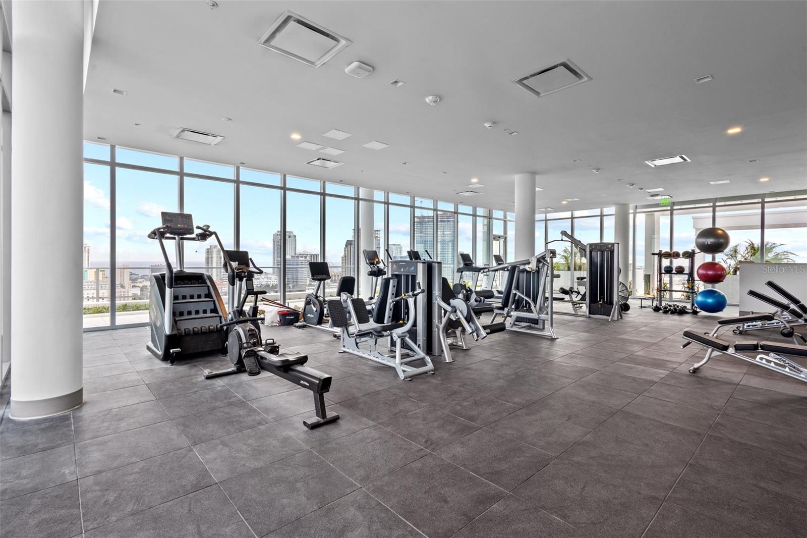 State-of-the-art fitness center with floor-to-ceiling windows and incredible elevated views.