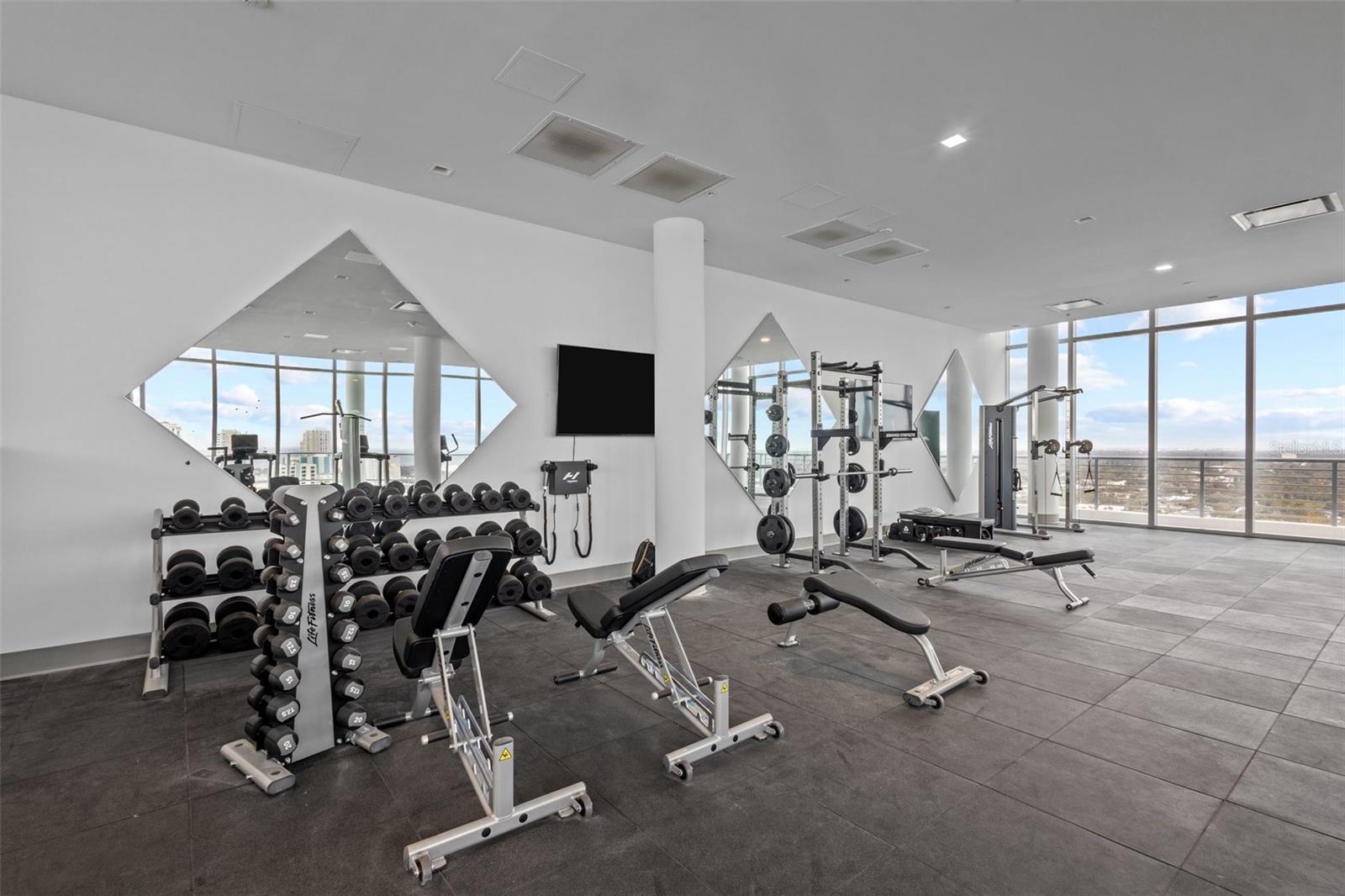 State-of-the-art fitness center with floor-to-ceiling windows and incredible elevated views.