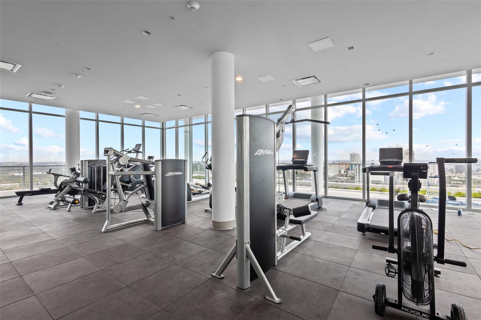 State-of-the-art fitness center with floor-to-ceiling windows and incredible elevated views.
