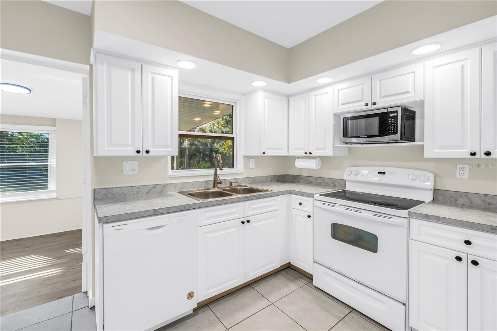 Kitchen window overlooks the backyard oasis