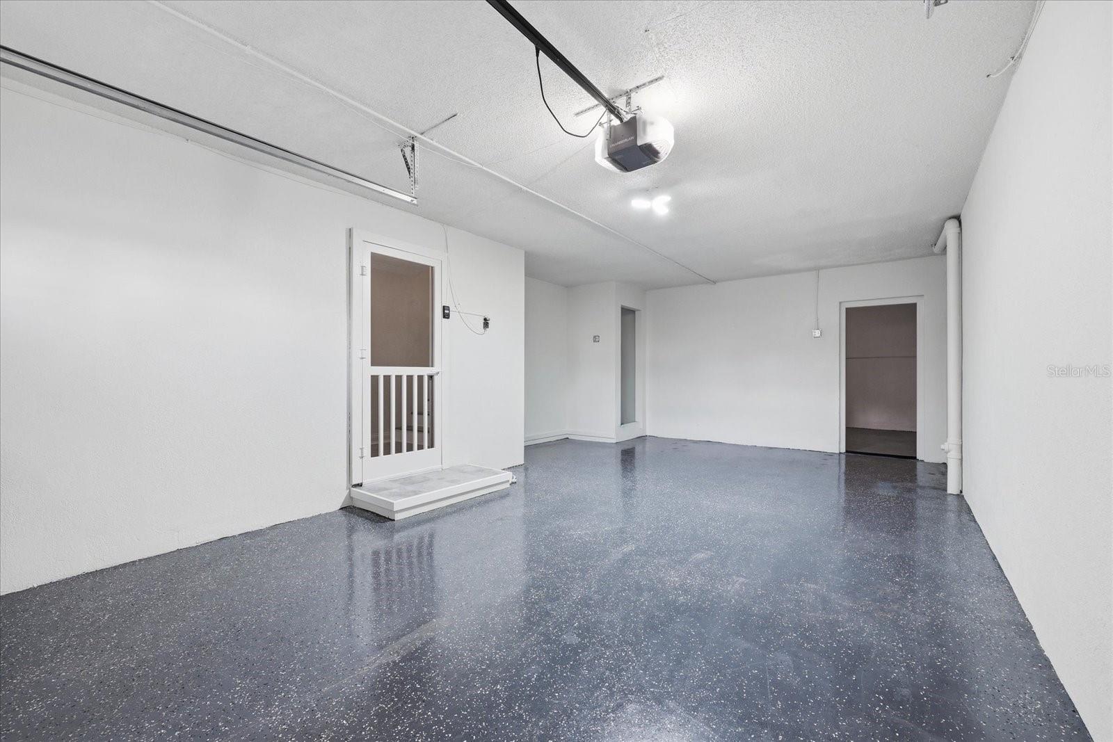 Oversized garage with storage and extra space for a golf cart too.