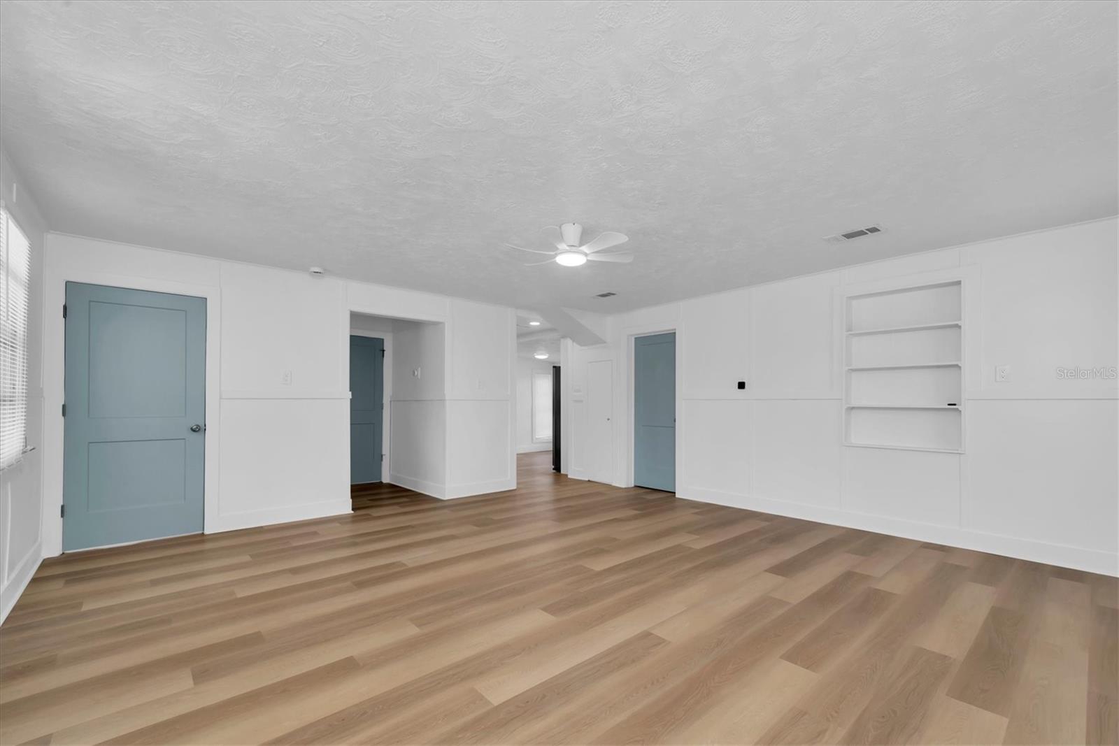 Living Area with Luxury Vinyl Tile, buit-in shelving, and lots of natural light