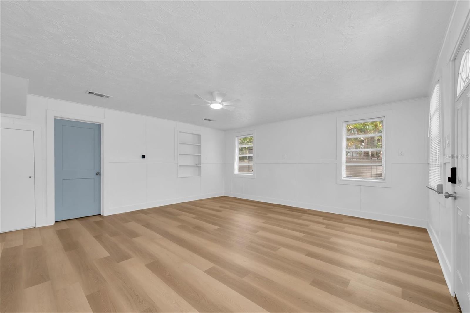 Living Area with Luxury Vinyl Tile, buit-in shelving, and lots of natural light
