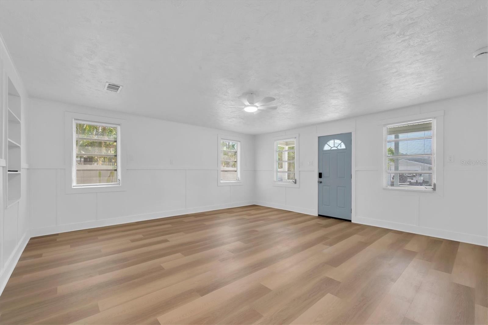 Living Area with Luxury Vinyl Tile, buit-in shelving, and lots of natural light