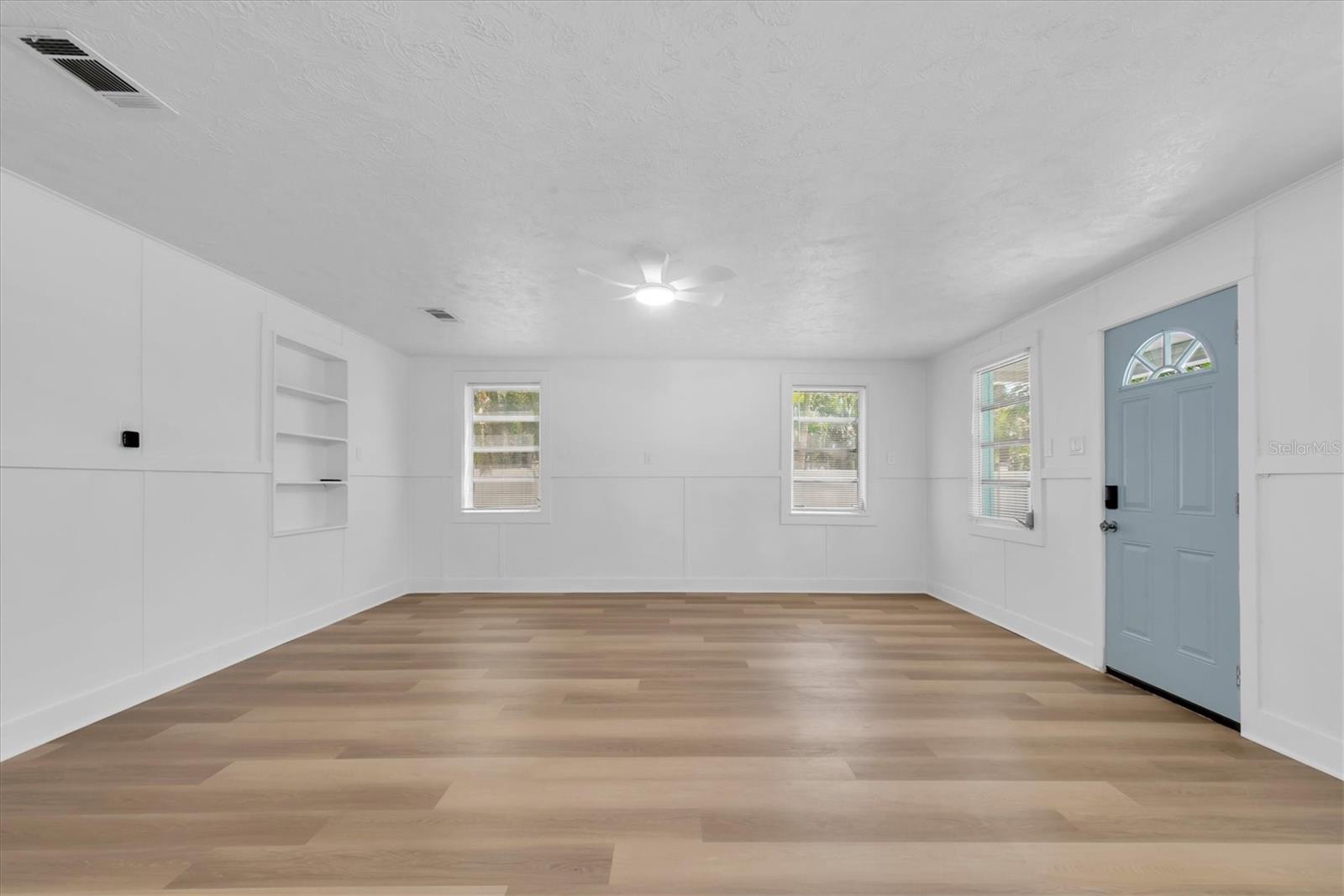 Living Area with Luxury Vinyl Tile, buit-in shelving, and lots of natural light