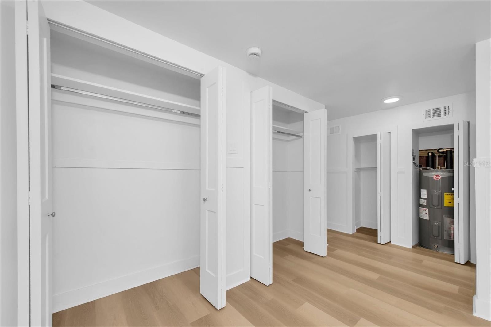 Bedroom 1 - Luxury Vinyl Tile flooring, his and her closets