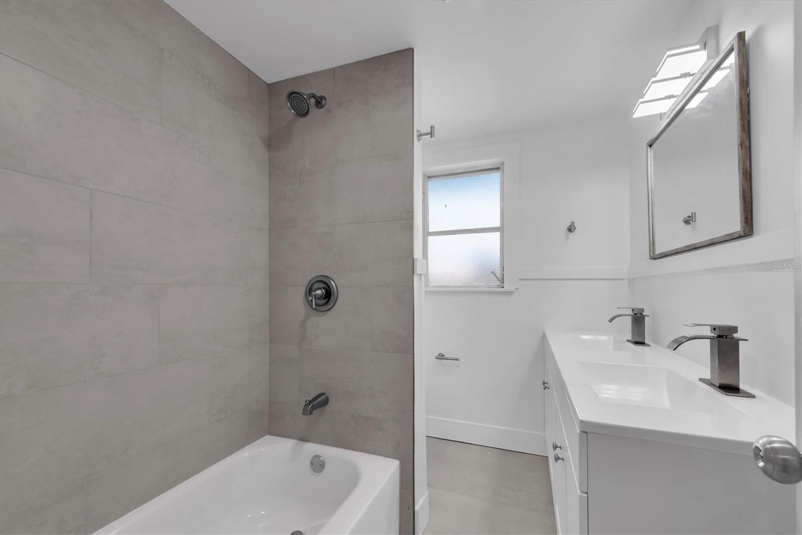 Bathroom 1 - Double Vanity and tiled tub/shower combo
