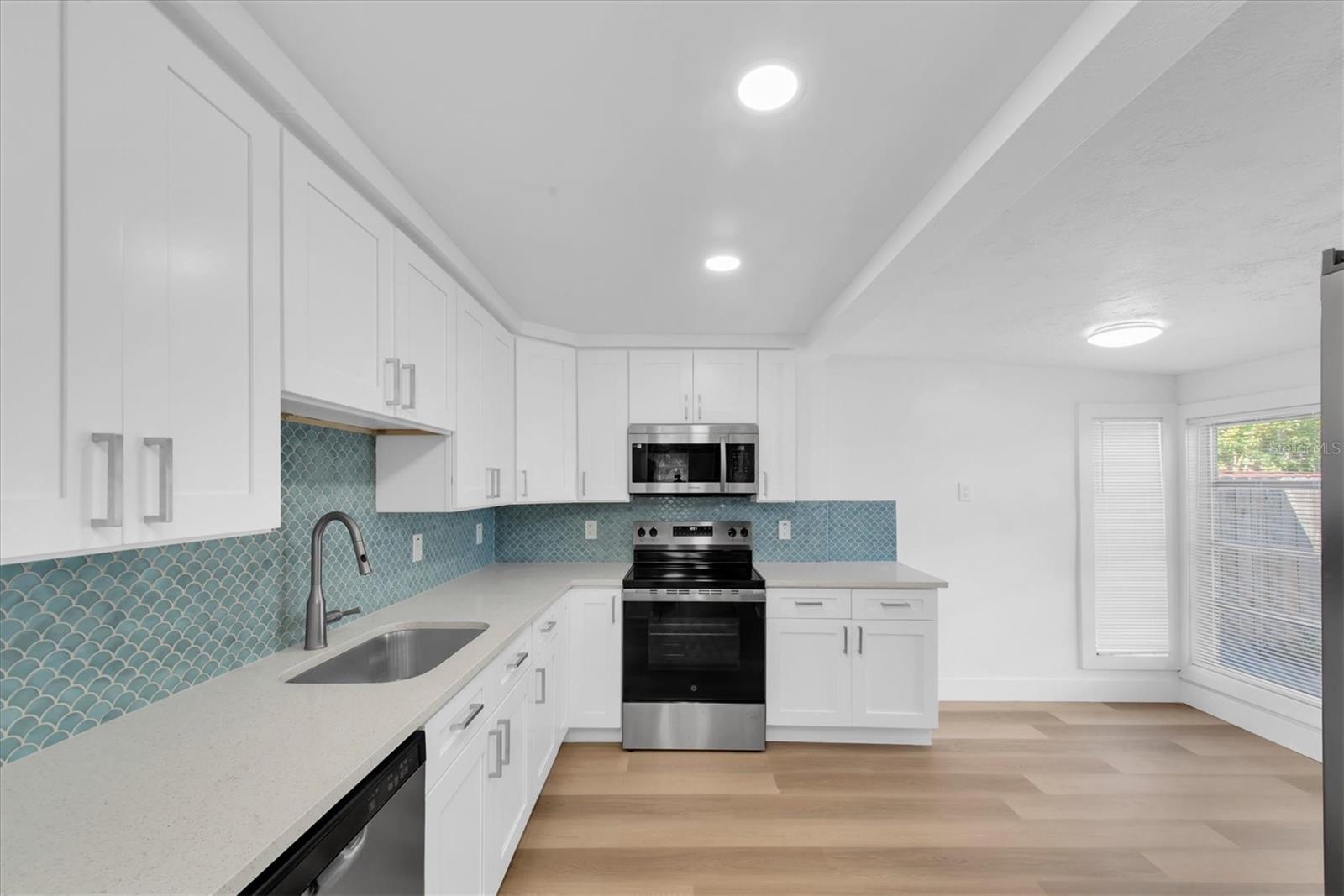 New Kitchen with Quartz Cabinets, white cabinets, tiled backspladh, recessed lighting, stainless steel appliances, including dishwasher