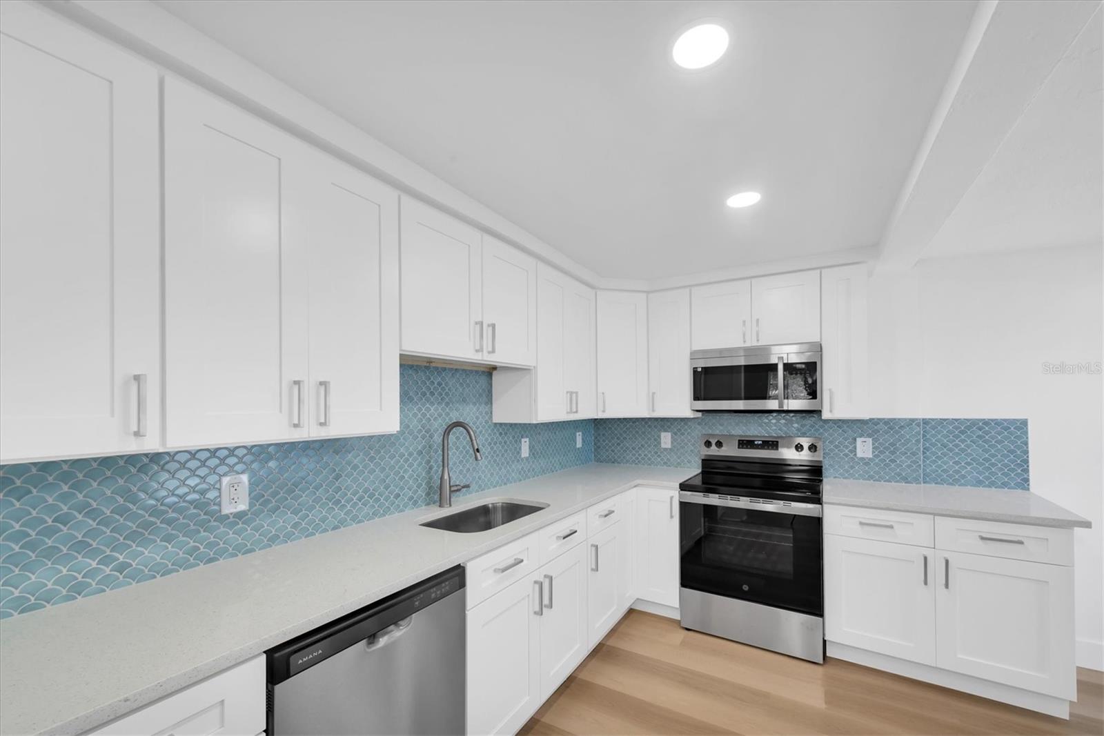 New Kitchen with Quartz Cabinets, white cabinets, tiled backspladh, recessed lighting, stainless steel appliances, including dishwasher
