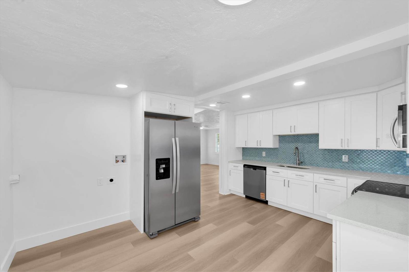 New Kitchen with Quartz Cabinets, white cabinets, tiled backspladh, recessed lighting, stainless steel appliances, including dishwasher