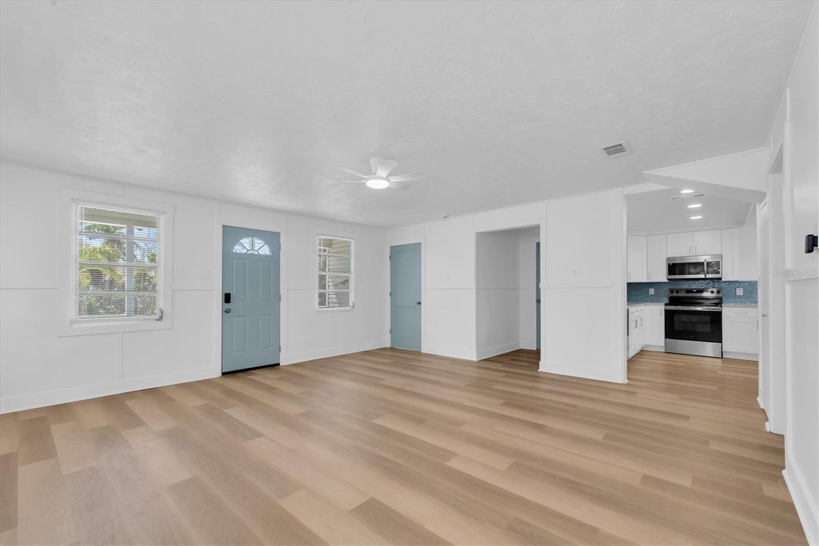Living Area with Luxury Vinyl Tile, buit-in shelving, and lots of natural light