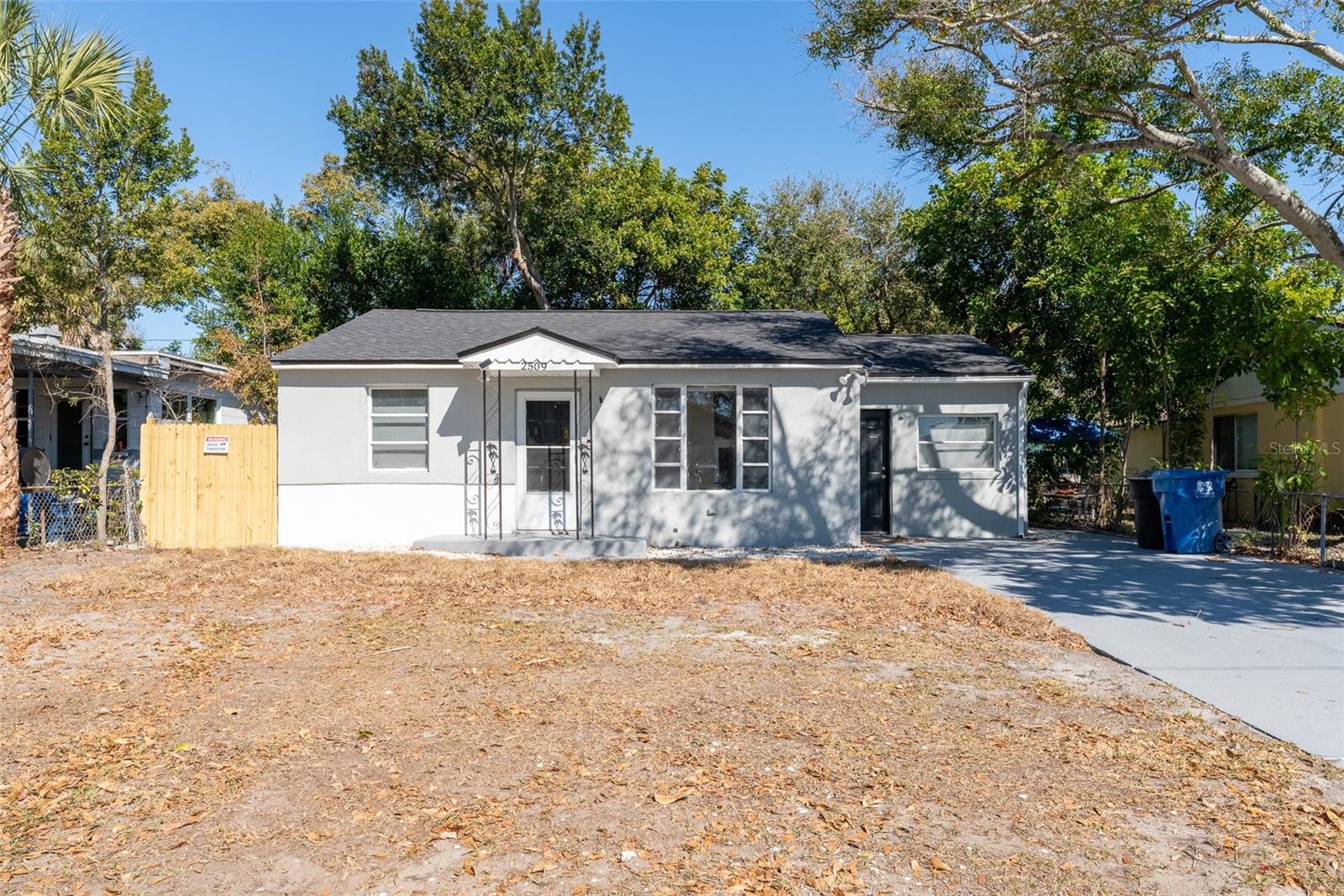 Fully renovated South St. Pete home with fresh modern curb appeal. Featuring a clean neutral exterior, covered front entry, spacious driveway, and a generous lot with room to create your ideal outdoor space — all just minutes from Downtown St. Petersburg. Move-in ready and full of potential.