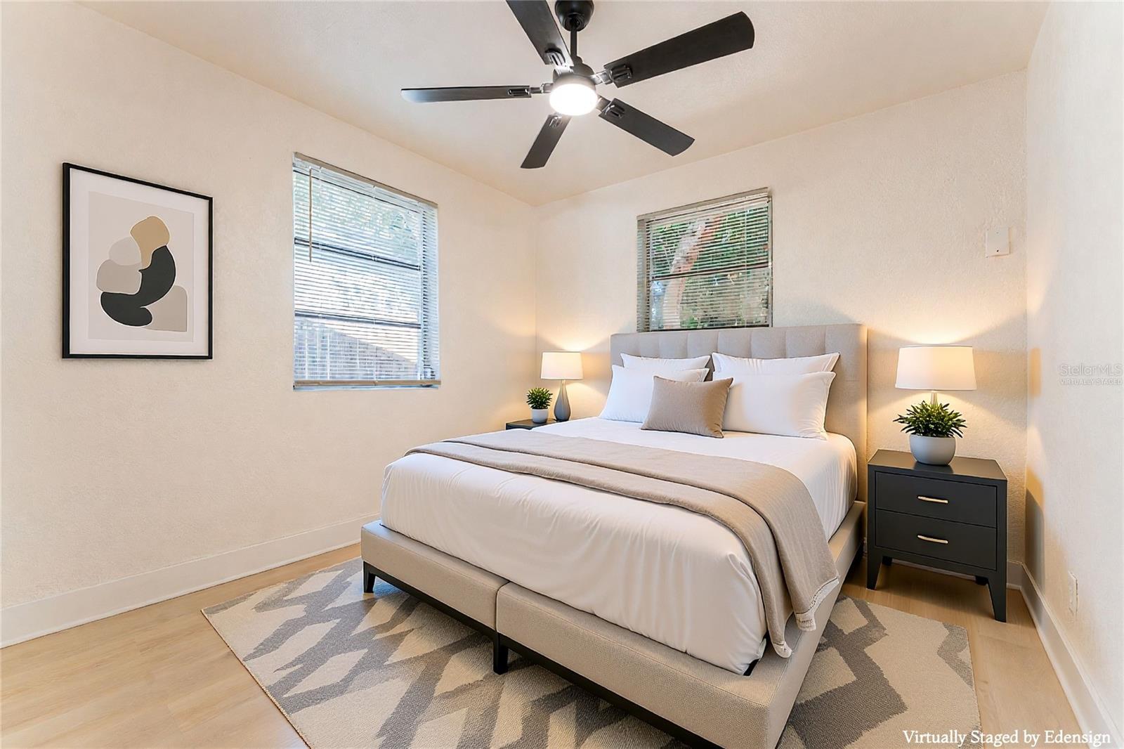 Bedroom #2 features a clean, functional layout with closet storage, updated flooring, and modern ceiling fan. Bright and versatile space. Virtually staged.