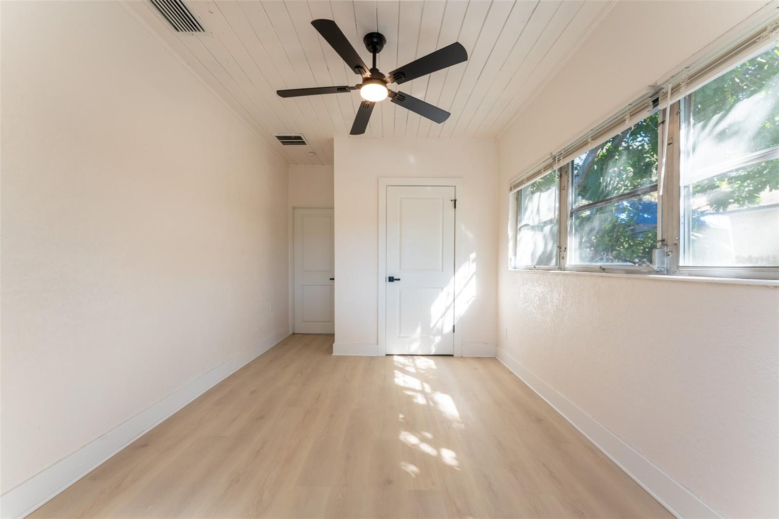Bedroom #3 includes its own private entrance, offering added flexibility for guests, extended family, or a home office. Fresh finishes and natural light complete the space.
