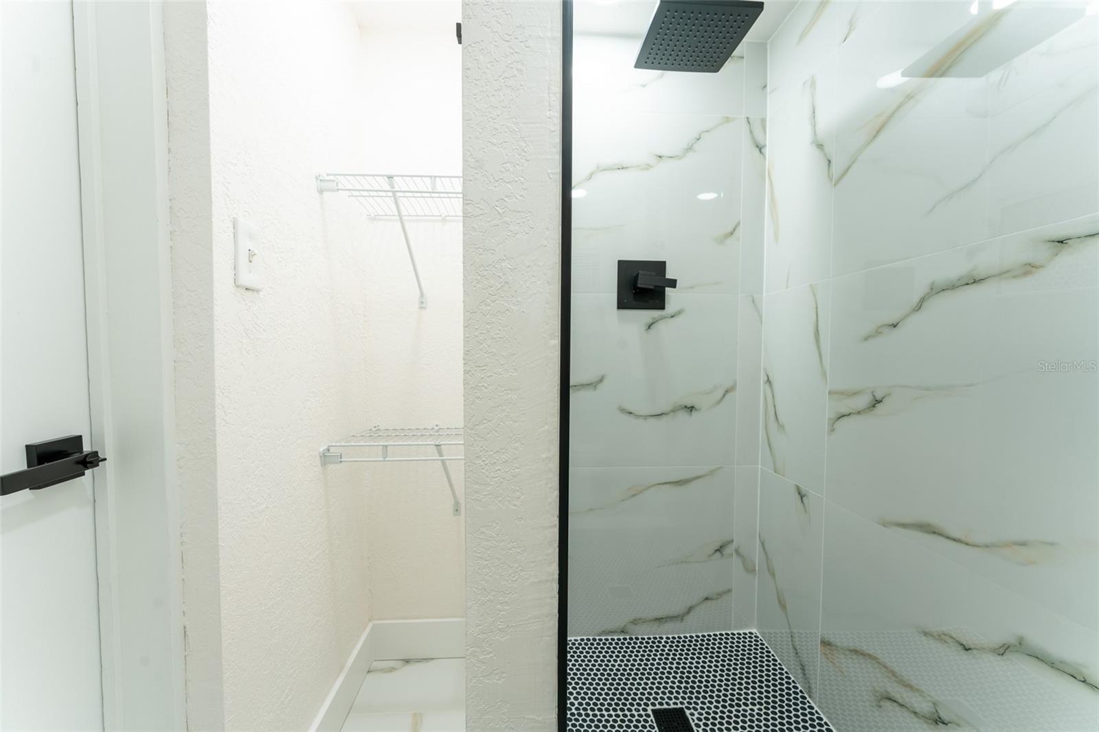 *Bonus full bathroom* with shower/tub combo featuring sleek large-format tile with modern marble-style accents. Clean lines and contemporary finishes create a fresh, spa-inspired feel while maintaining everyday functionality.
