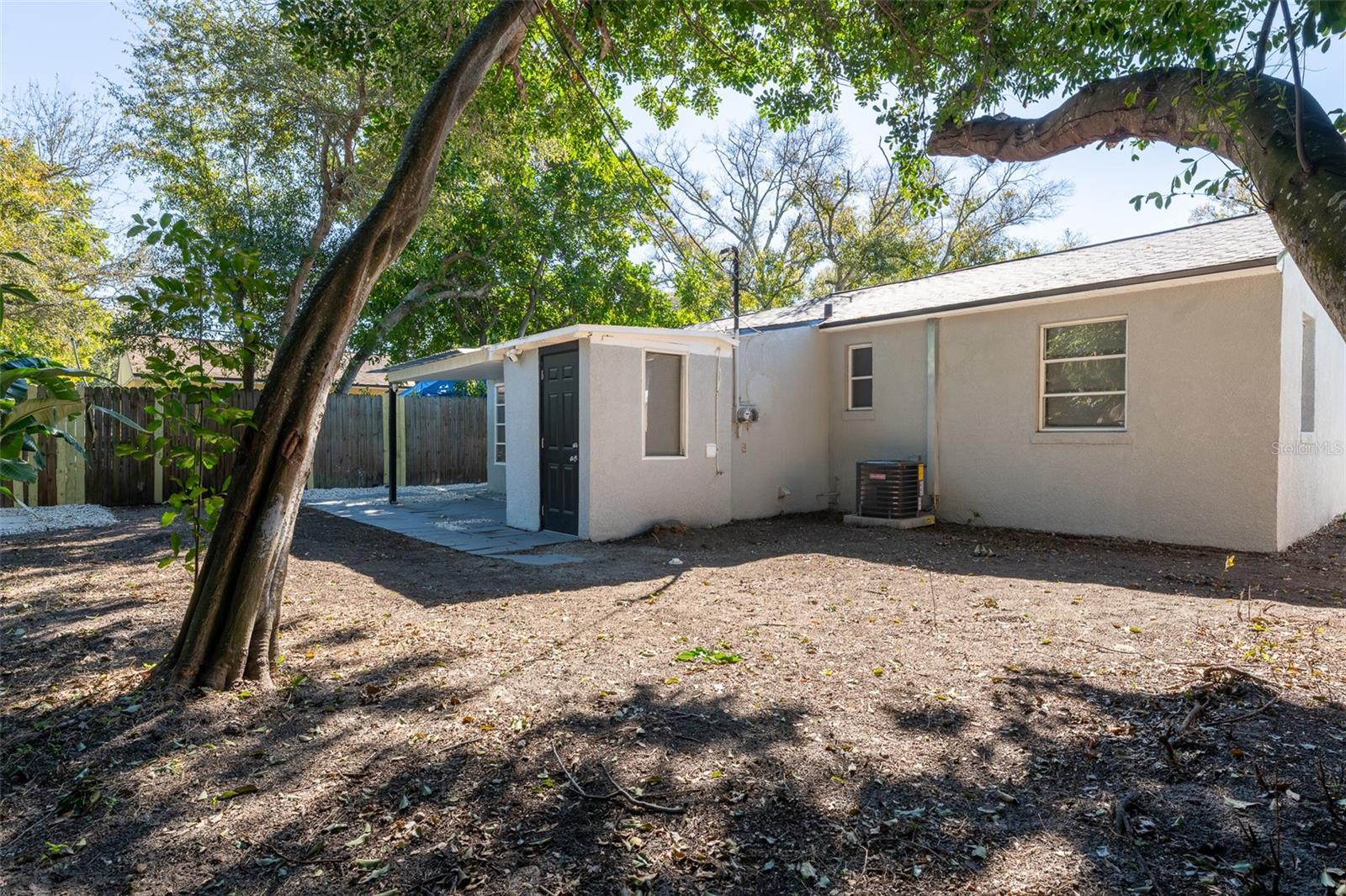 Spacious backyard surrounded by mature trees and lush greenery, offering natural shade and privacy. This oversized outdoor space is a true blank canvas — ready for a garden, play area, pool, or custom outdoor entertaining setup to fit your vision.