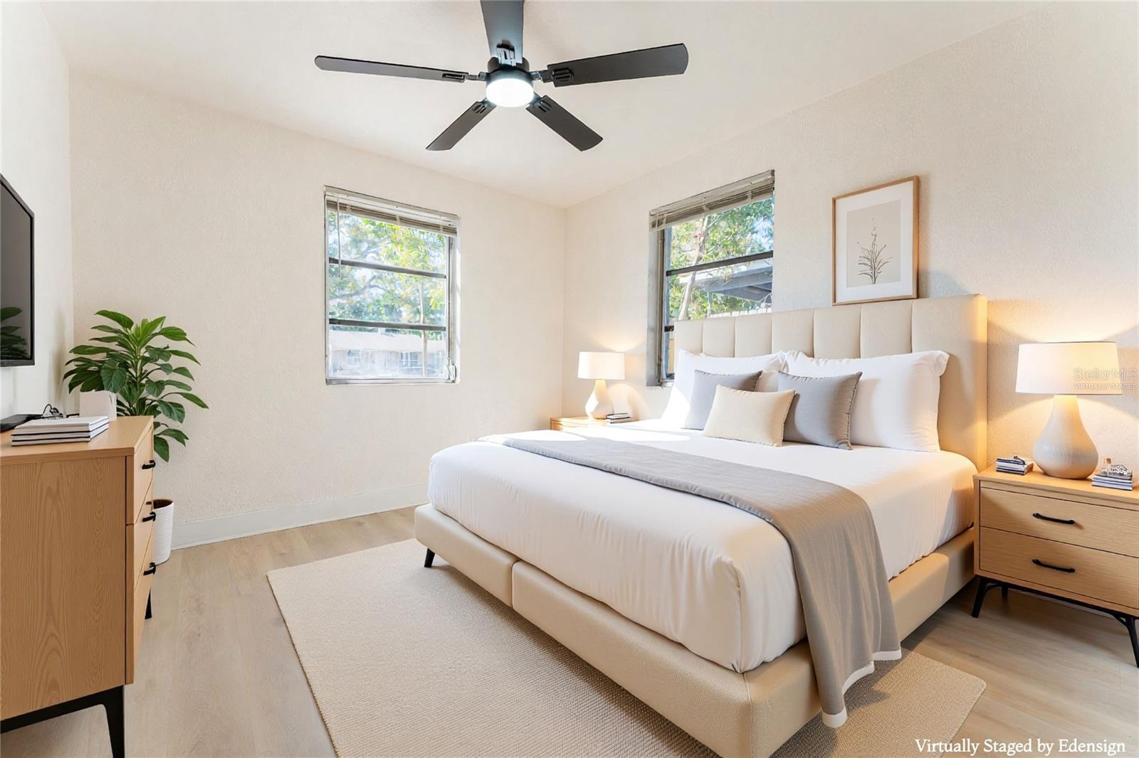 Bedroom #1 — enter into your bedroom retreat featuring modern finishes, updated flooring, and a sleek ceiling fan for added comfort. Ample wall space allows for flexible furniture placement. Virtually staged to showcase layout and design potential.