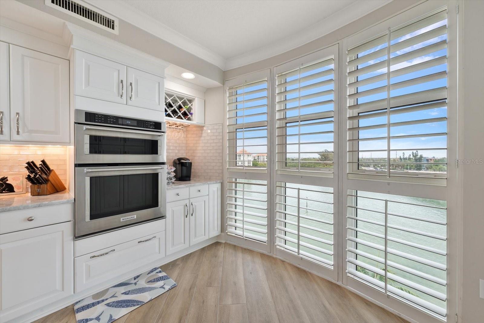 Stainless steel Kitchen Aid oven and microwave.  The corner cabinets and counter serves as a coffee station, or could be a nice dry bar