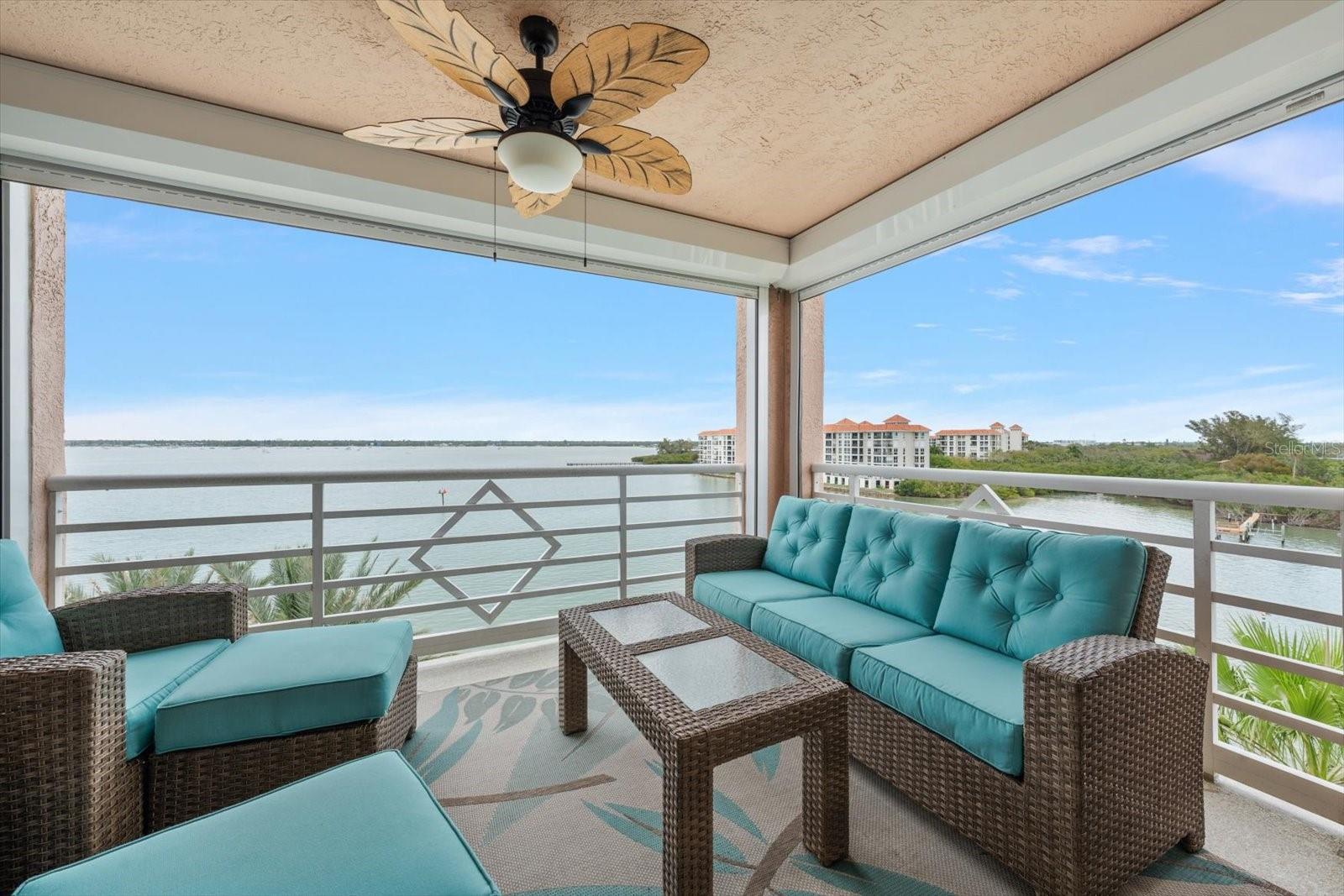 Balcony with newer hurricane shutters and ceiling fan.  What a cool place to relax!