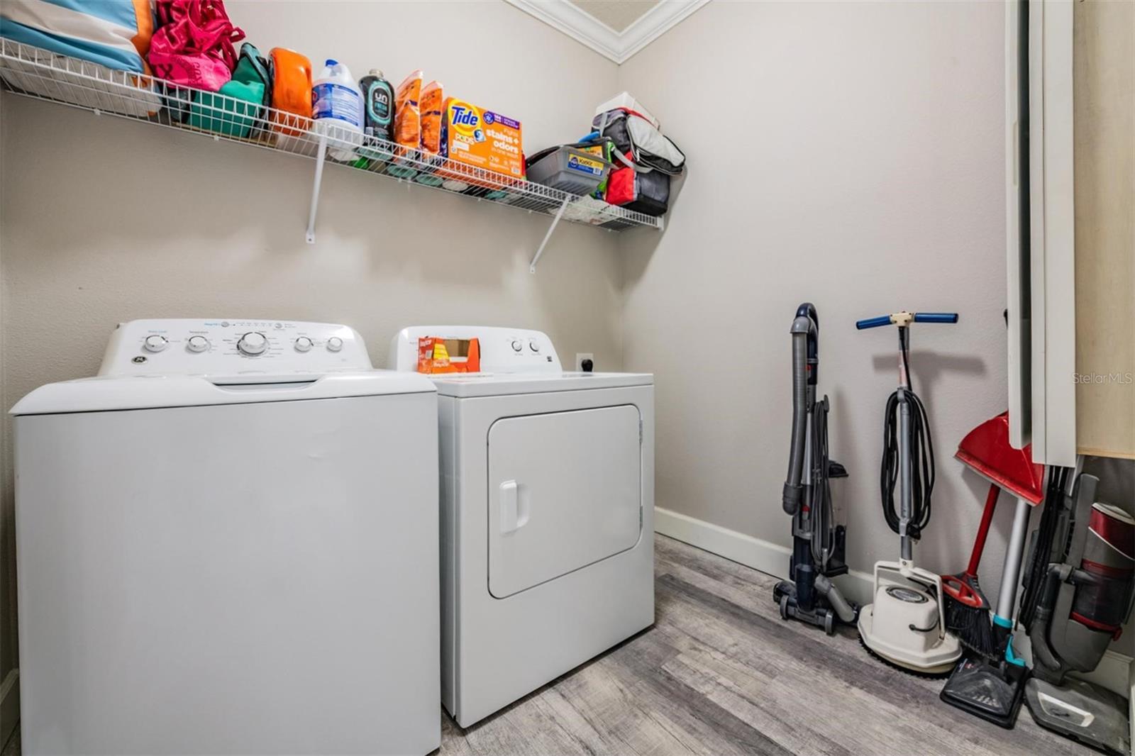 Laundry room w/upgraded flooring & crown molding