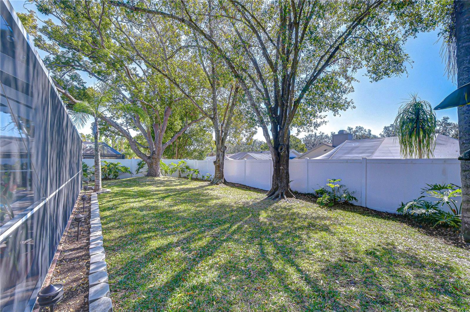 Lush tropical landscaping surround the yard!